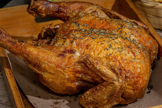 Stock photo of a whole roasted chicken representing what a corn free, soy free, pasture raised chicken from Onward Homestead can look like when cooked at home.